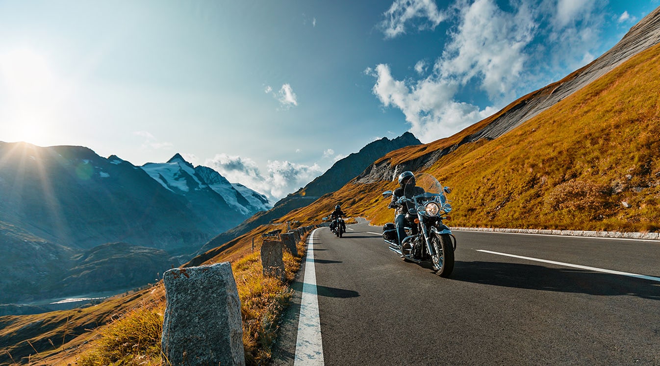 Motorcycle driver riding in Alpine highway